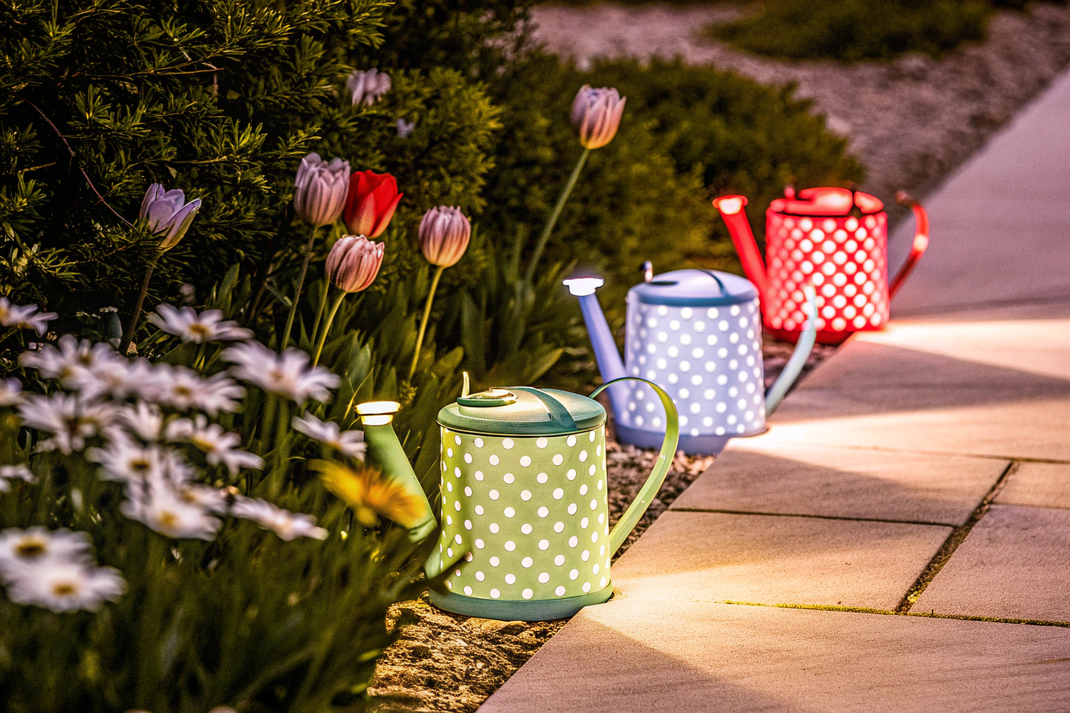 Dekorative Solarlampen in Form von Gießkannen im Garten. Garten-Dekoration mit Solarlampen