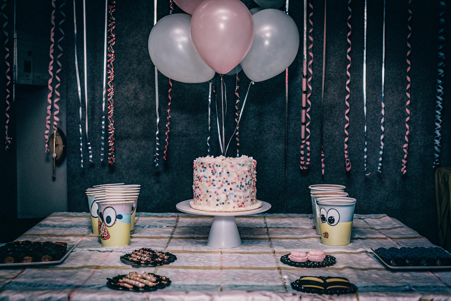 Ein festlich gedeckter Tisch mit buntem Partygeschirr und Dekorationen. Festlich gedeckter Tisch für eine Kinderparty